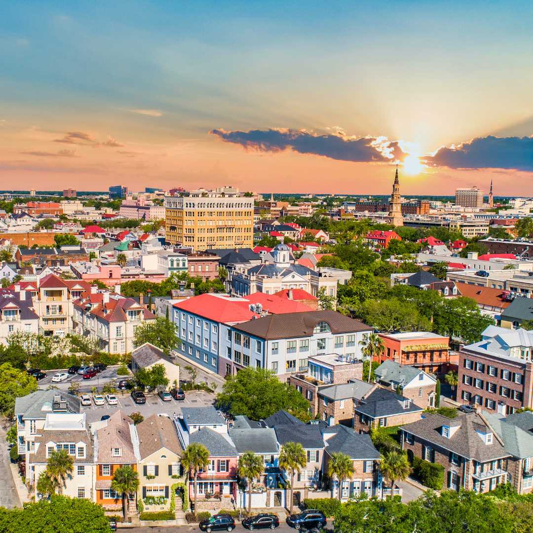 ashley river bridge connecting west ashley to downtown charleston An aerial view of downtown Charleston with a sunset on the horizon